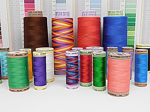 100% long staple, mercerized Egyptian cotton thread. 28, 40, 50 and 60-Weight, along with color cards for reference.